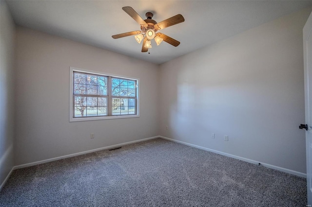 empty room with ceiling fan and carpet