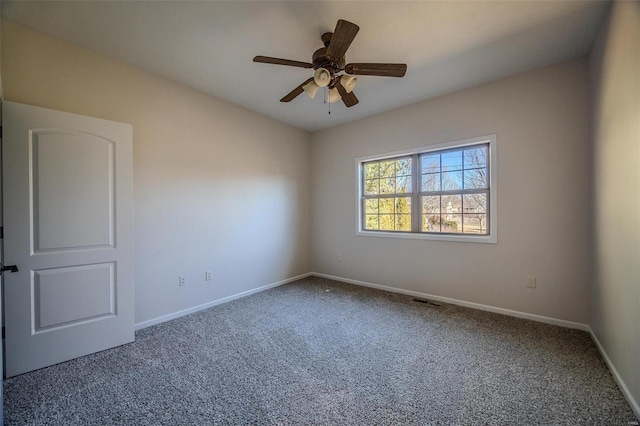 carpeted spare room featuring ceiling fan