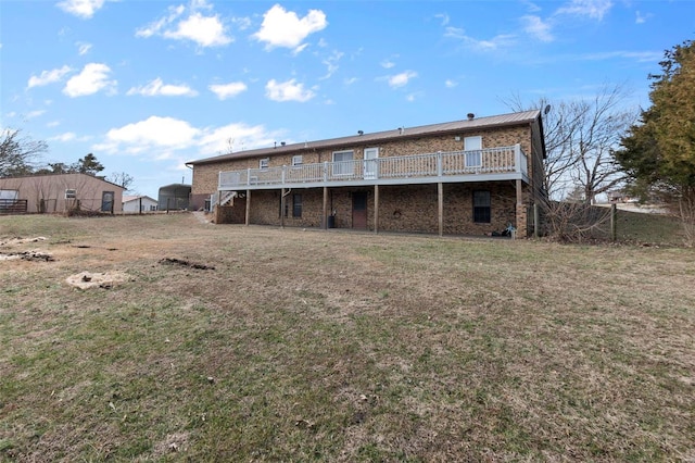 rear view of property with a yard and a deck