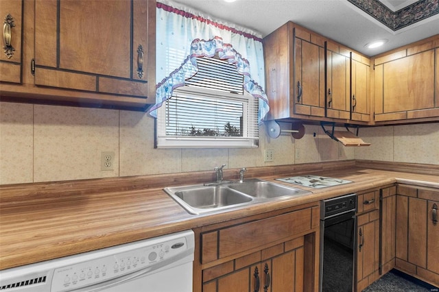 kitchen featuring white dishwasher and sink