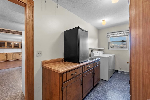 washroom with cabinets and a textured ceiling