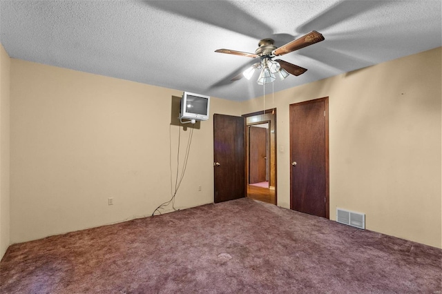 unfurnished bedroom with ceiling fan, carpet flooring, and a textured ceiling