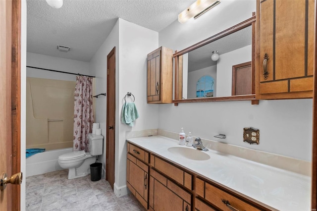 full bathroom with shower / tub combo with curtain, vanity, toilet, and a textured ceiling