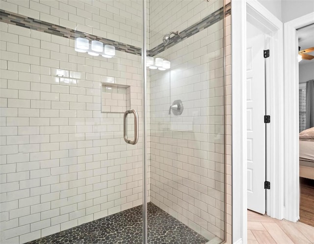 bathroom featuring hardwood / wood-style flooring and walk in shower