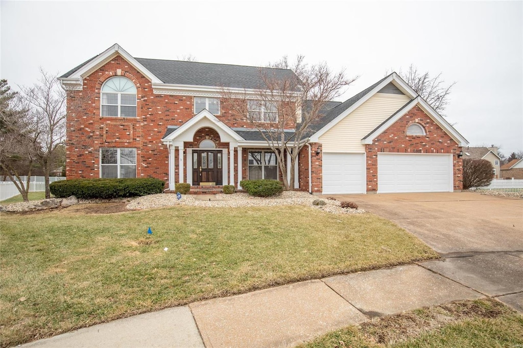 front of property with a garage and a front yard