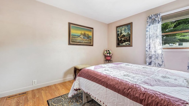 bedroom with hardwood / wood-style flooring