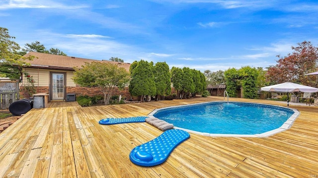 view of swimming pool with a deck