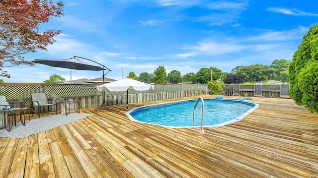 view of swimming pool with a deck