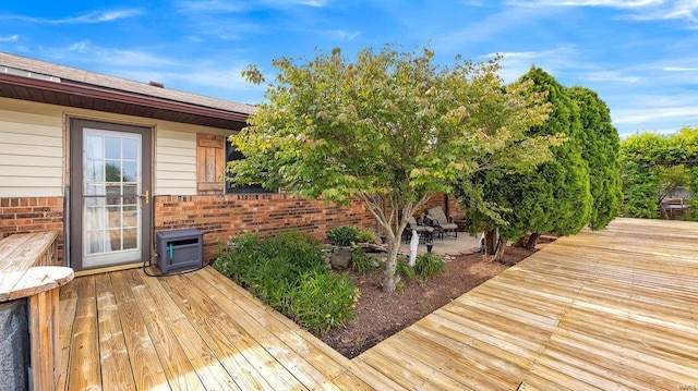 wooden deck featuring a wall mounted AC