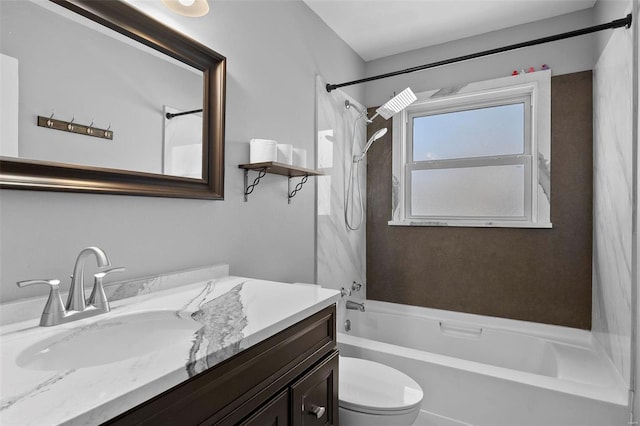 full bathroom with vanity, tiled shower / bath combo, and toilet