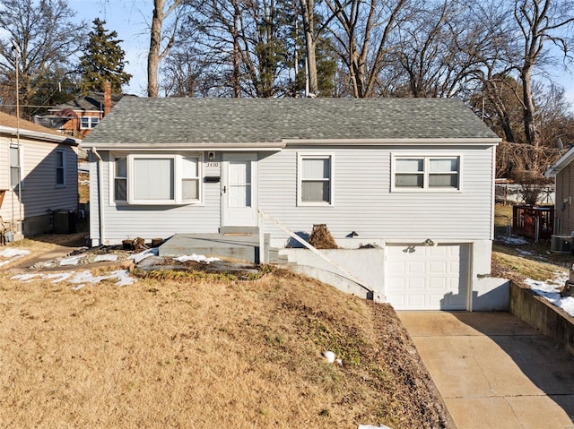 view of front of home featuring a garage and central AC