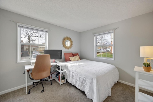 bedroom with a textured ceiling and carpet flooring