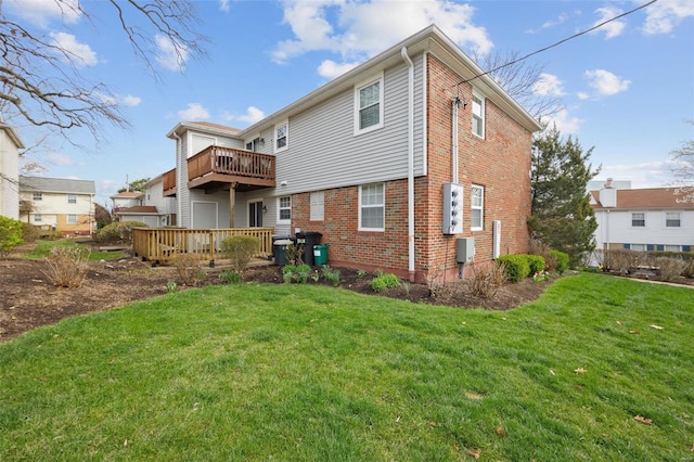 rear view of house featuring a yard and a deck