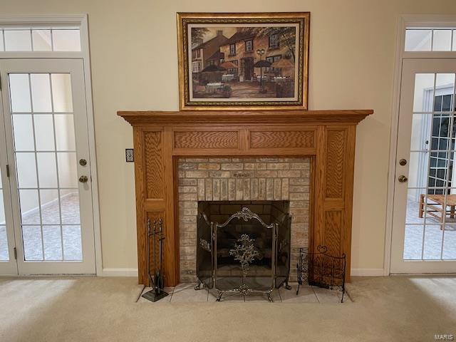 room details with carpet flooring and a brick fireplace