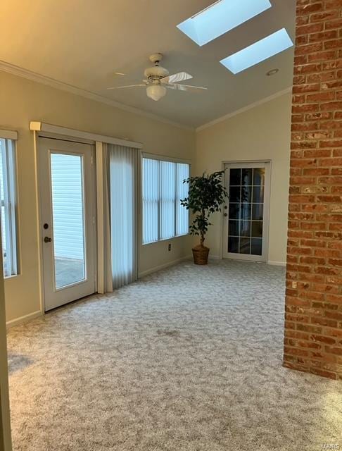 carpeted empty room featuring ceiling fan, lofted ceiling, and ornamental molding