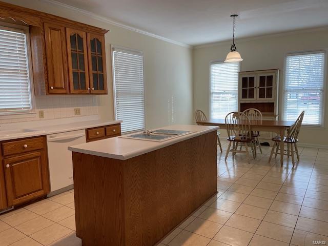 kitchen featuring hanging light fixtures, a kitchen island, light tile patterned floors, and white dishwasher