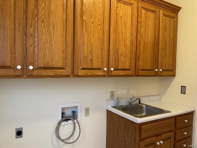 washroom with cabinets, electric dryer hookup, sink, and hookup for a washing machine