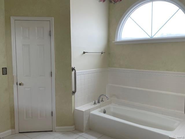 bathroom featuring a bath and tile patterned floors