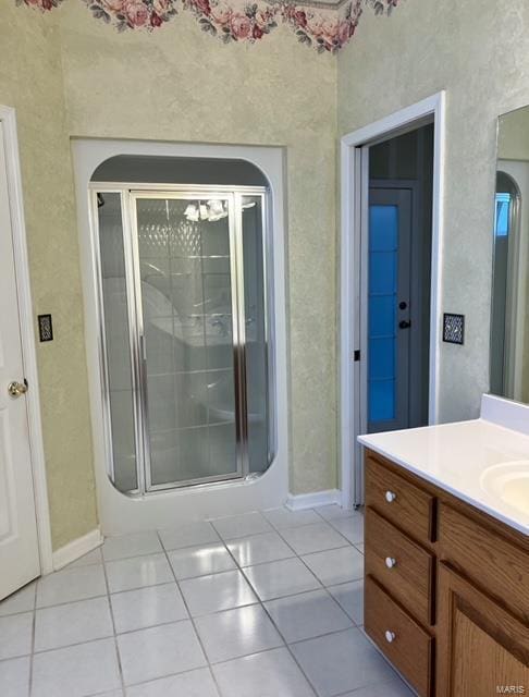 bathroom with vanity, a shower with door, and tile patterned floors