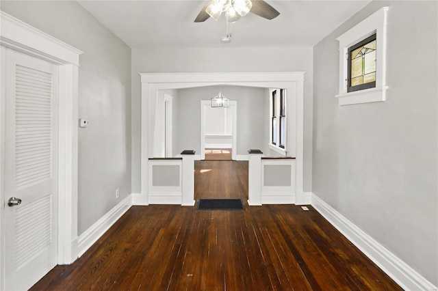 hallway with dark hardwood / wood-style flooring