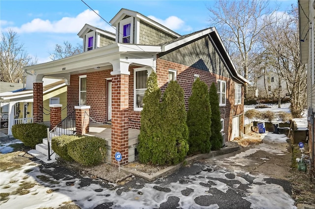 view of snow covered exterior featuring a porch