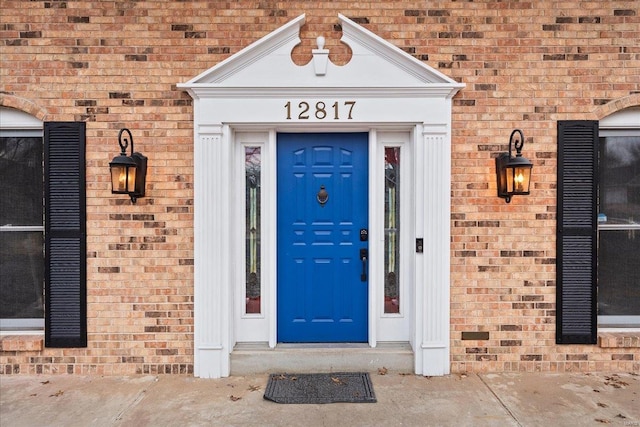 property entrance with brick siding