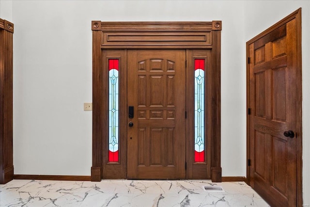 entryway featuring visible vents, baseboards, and marble finish floor