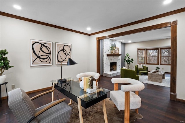 living room featuring a premium fireplace, baseboards, wood finished floors, and crown molding