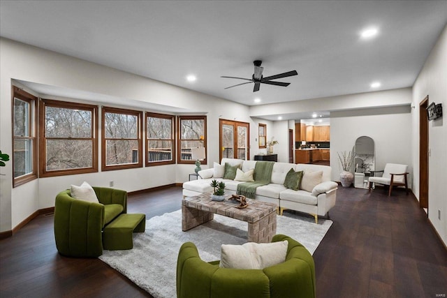 living area with dark wood-style floors, recessed lighting, a ceiling fan, and baseboards