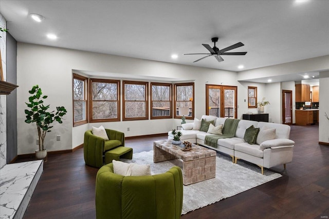 living area featuring dark wood-style floors, recessed lighting, a premium fireplace, baseboards, and ceiling fan