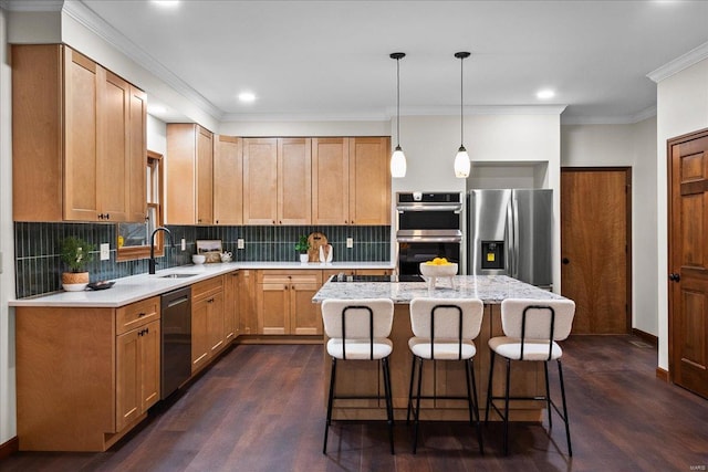 kitchen featuring a sink, a kitchen island, a kitchen bar, appliances with stainless steel finishes, and dark wood-style flooring