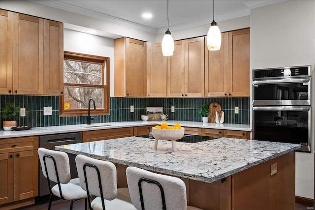 kitchen featuring tasteful backsplash, dishwashing machine, double oven, and a sink