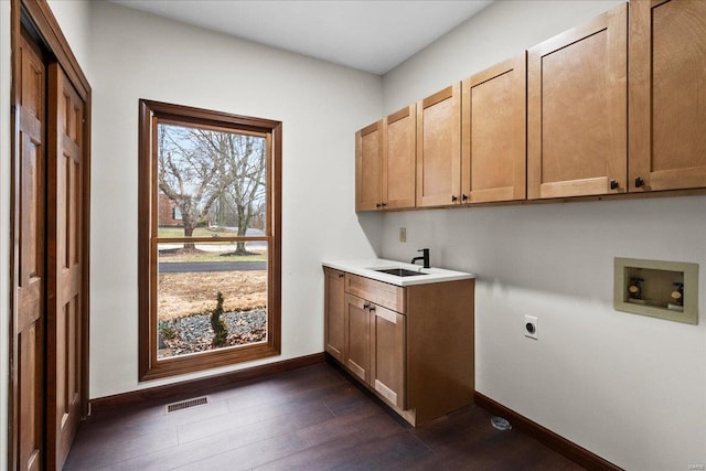 laundry room with visible vents, cabinet space, a sink, washer hookup, and electric dryer hookup