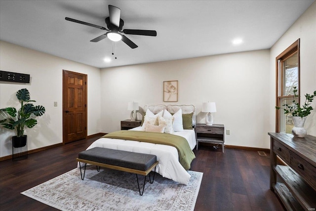 bedroom with ceiling fan, baseboards, and wood finished floors