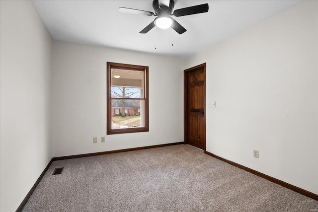 empty room featuring baseboards, carpet floors, visible vents, and ceiling fan