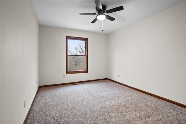 spare room with baseboards, carpet floors, and a ceiling fan