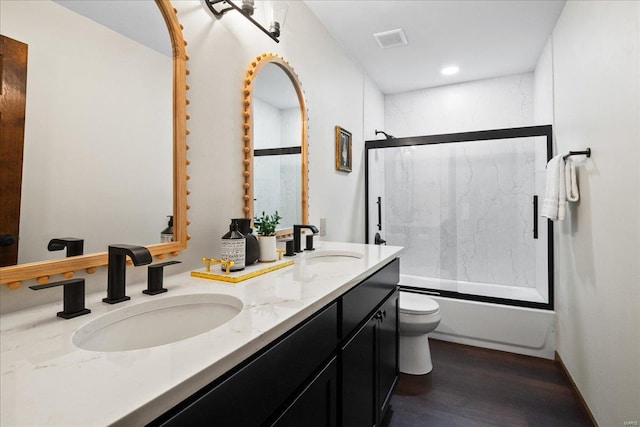 full bathroom featuring a sink, visible vents, toilet, and double vanity