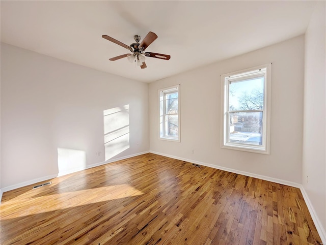 unfurnished room with ceiling fan and wood-type flooring