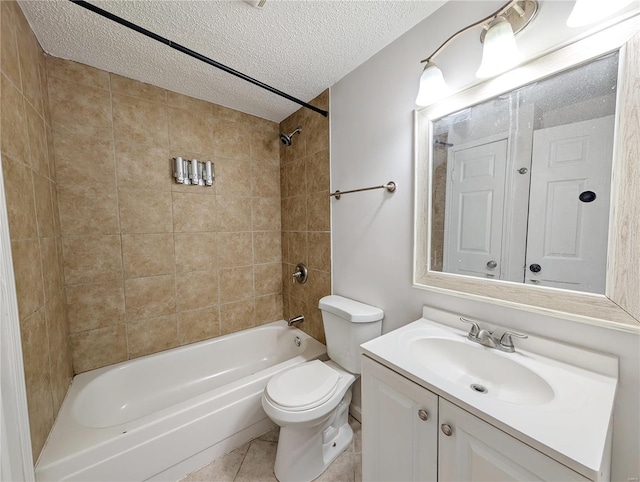 full bathroom with tiled shower / bath combo, vanity, toilet, tile patterned floors, and a textured ceiling