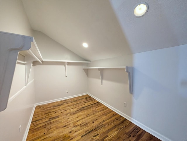 walk in closet featuring vaulted ceiling and hardwood / wood-style floors