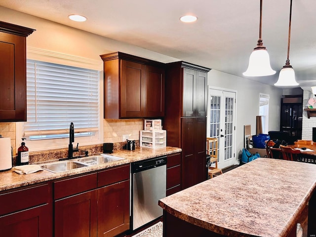 kitchen featuring sink, hanging light fixtures, a center island, stainless steel dishwasher, and french doors