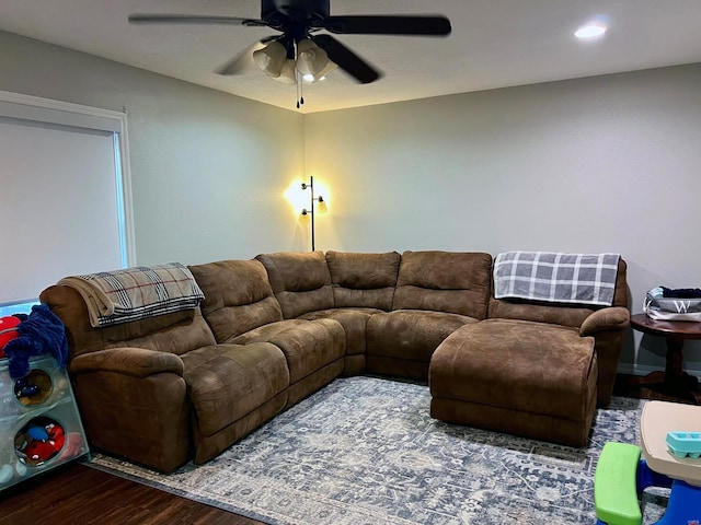 living room with wood-type flooring and ceiling fan