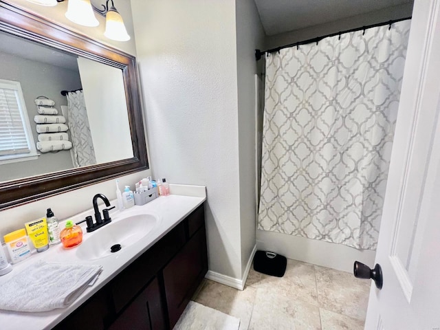 bathroom featuring vanity and shower / bathtub combination with curtain