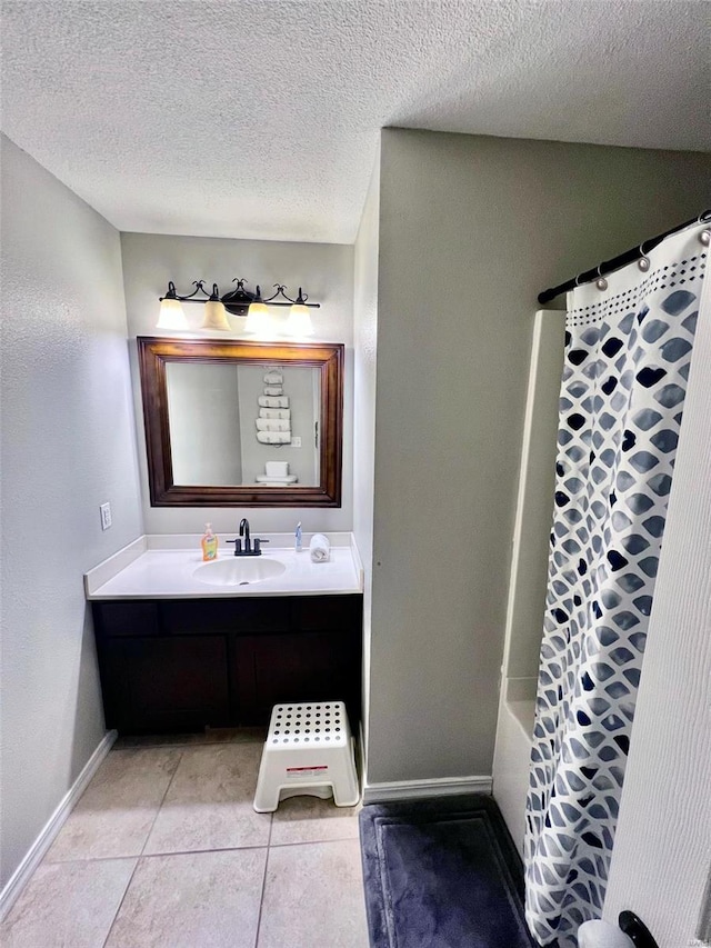 bathroom featuring tile patterned flooring, vanity, shower / tub combo, and a textured ceiling