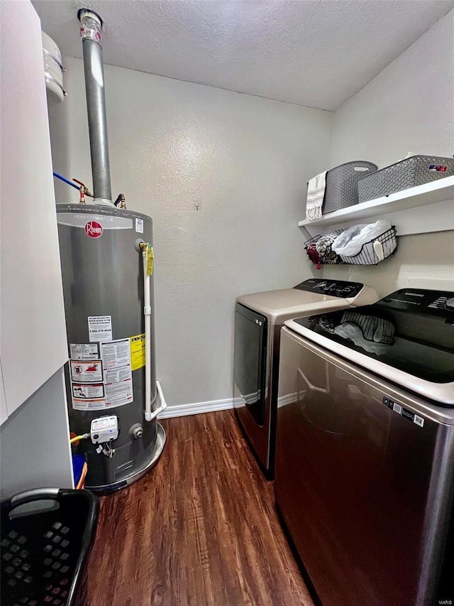 washroom featuring dark wood-type flooring, washer and clothes dryer, a textured ceiling, and gas water heater