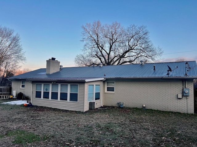 view of back house at dusk