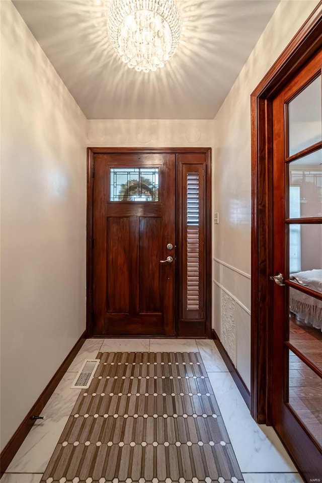 entryway featuring a chandelier