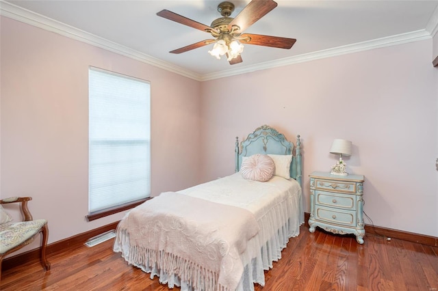 bedroom with multiple windows, hardwood / wood-style flooring, ornamental molding, and ceiling fan