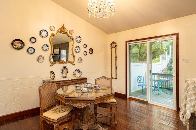 dining room featuring dark hardwood / wood-style flooring, vaulted ceiling, and an inviting chandelier