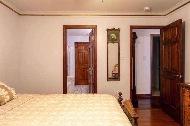 bedroom with connected bathroom, crown molding, and hardwood / wood-style flooring